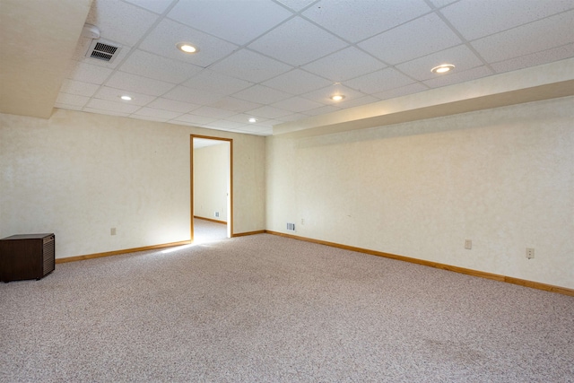 spare room featuring carpet floors and a paneled ceiling