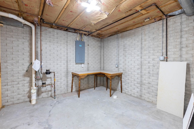 basement with brick wall and electric panel