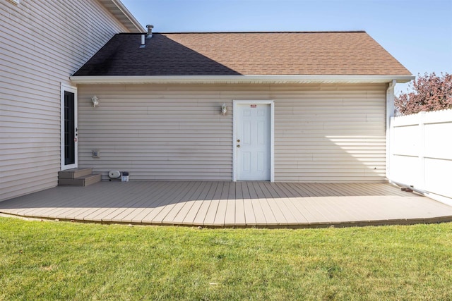 rear view of property featuring a yard and a wooden deck