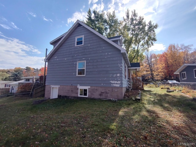 view of side of home featuring a yard