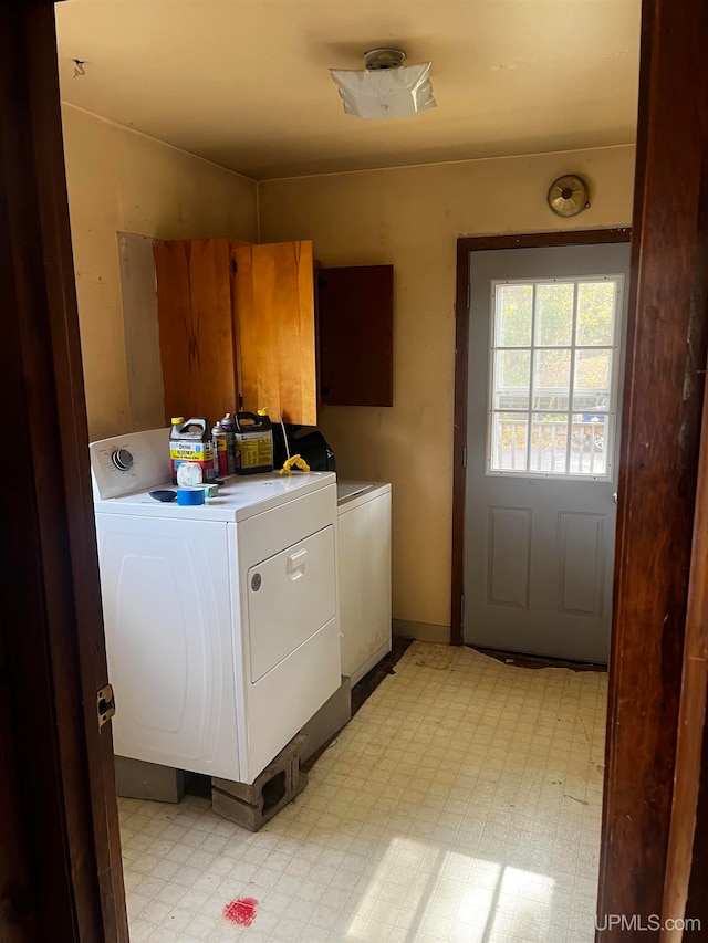 laundry area with cabinets and washer and clothes dryer