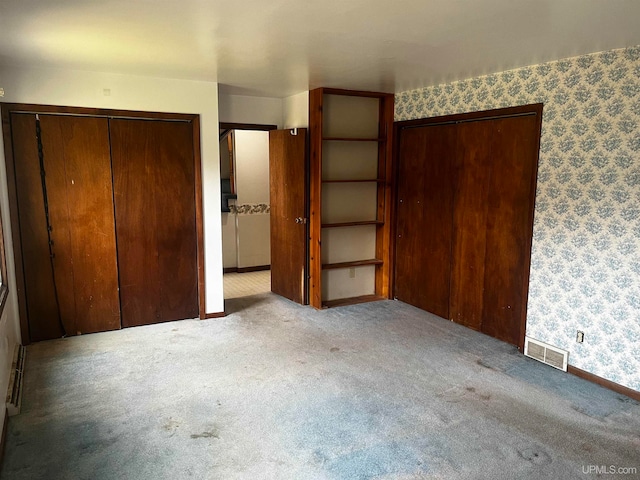 unfurnished bedroom with light colored carpet