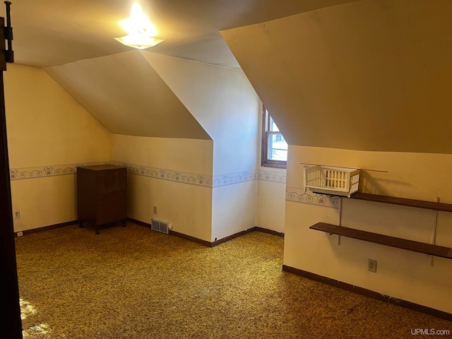 bonus room featuring lofted ceiling and carpet flooring