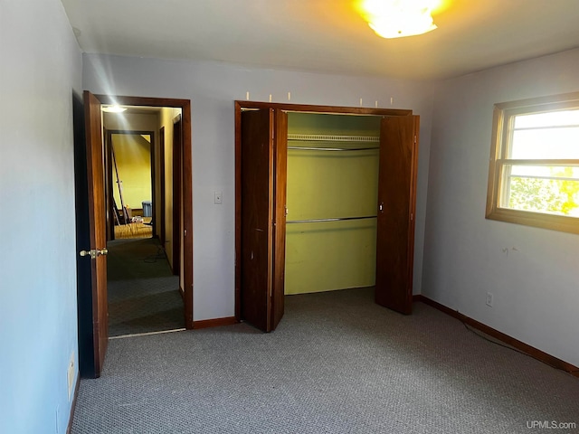 unfurnished bedroom featuring a closet and carpet flooring