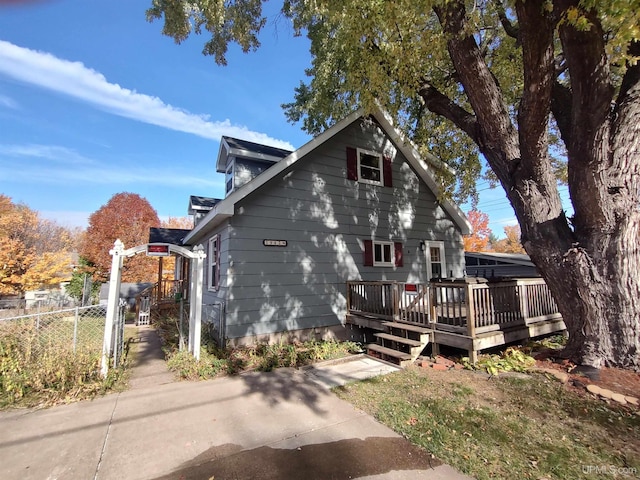 view of property exterior featuring a wooden deck