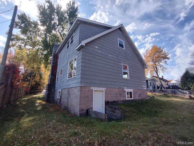 view of property exterior featuring a lawn