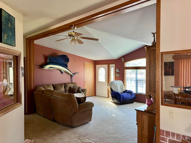 living room featuring ceiling fan, lofted ceiling, and carpet floors