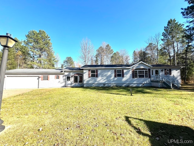 view of front of property featuring a front lawn and a garage