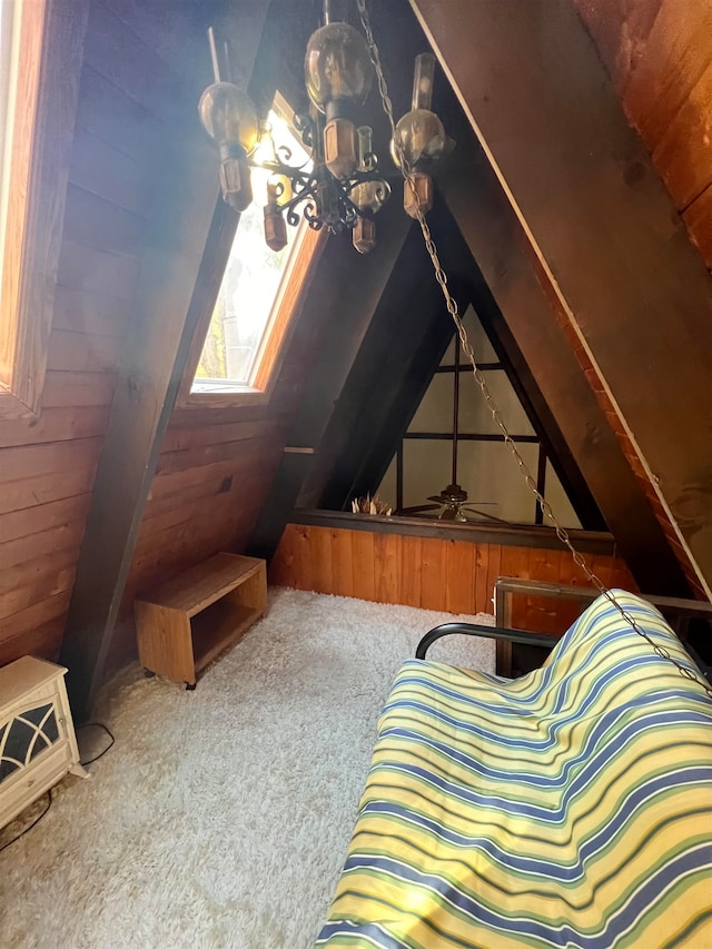 bonus room with wood walls, carpet floors, and lofted ceiling