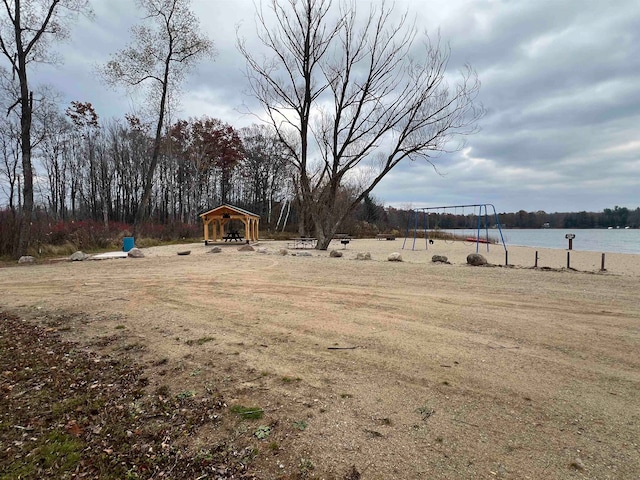 view of yard featuring a water view and a playground