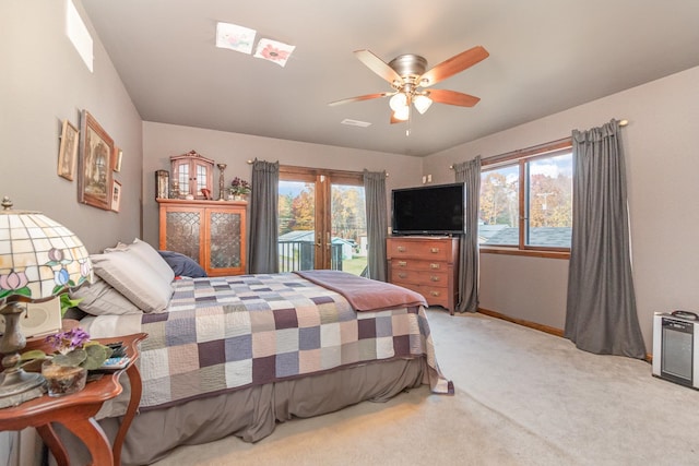 bedroom with light carpet, multiple windows, access to outside, and ceiling fan