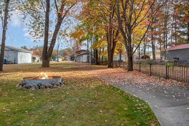 view of yard with an outdoor fire pit