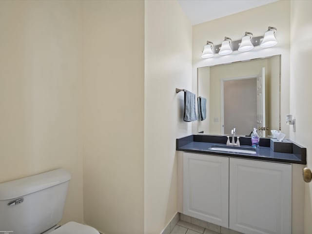 bathroom featuring vanity, toilet, and tile patterned flooring