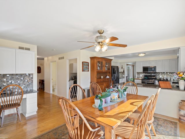 dining room featuring light hardwood / wood-style floors and ceiling fan