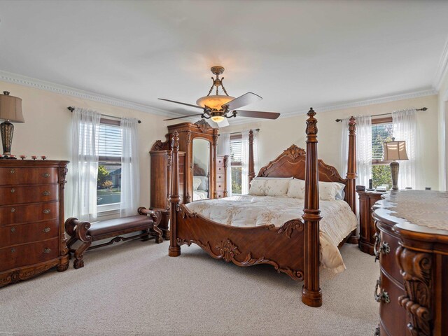 carpeted bedroom featuring crown molding, multiple windows, and ceiling fan