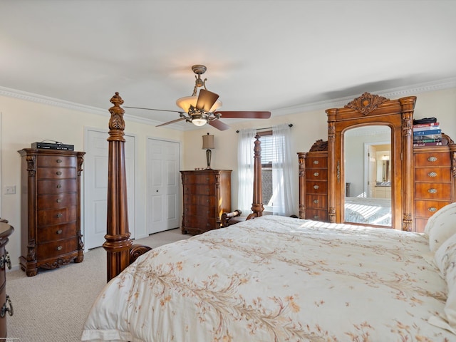 bedroom featuring crown molding, light carpet, and ceiling fan