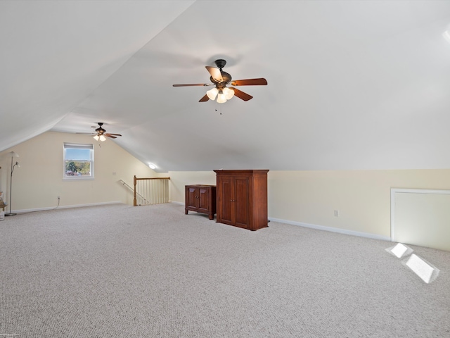 additional living space with baseboards, ceiling fan, light colored carpet, and lofted ceiling