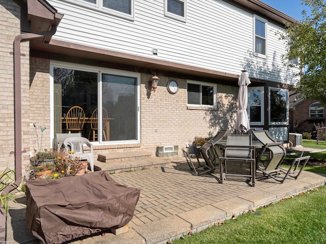 rear view of property featuring central air condition unit and a patio area