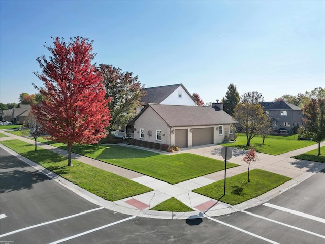 view of front of home with a garage and a front lawn