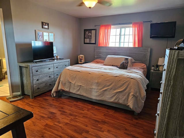 bedroom with dark hardwood / wood-style floors, ensuite bath, and ceiling fan