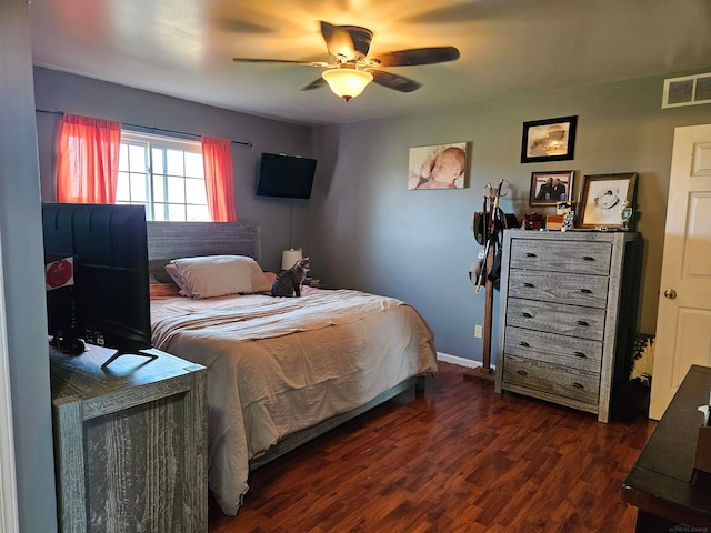 bedroom with dark hardwood / wood-style floors and ceiling fan