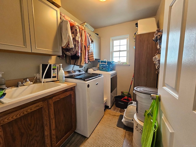 washroom featuring cabinets, light tile patterned flooring, washer and dryer, and sink