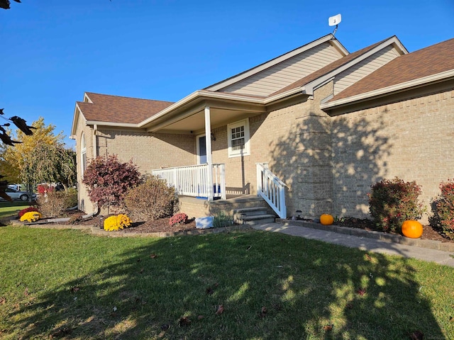 entrance to property with a lawn