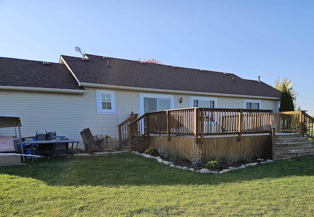 back of property with a yard and a wooden deck