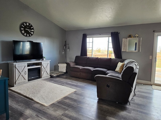 living room with dark wood-type flooring and vaulted ceiling