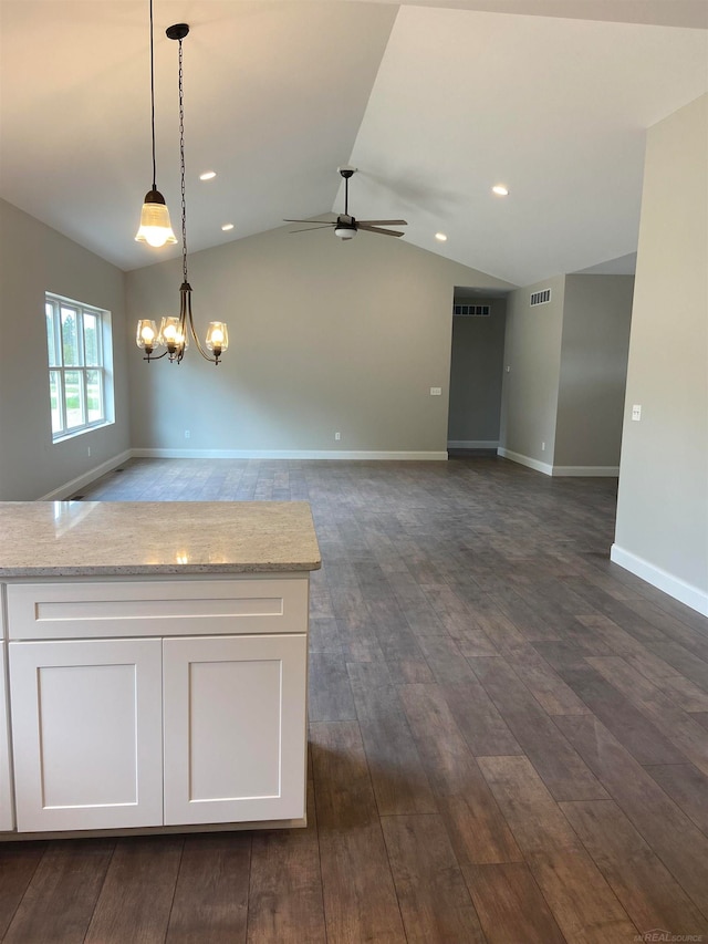 kitchen featuring pendant lighting, dark hardwood / wood-style floors, light stone counters, and white cabinets