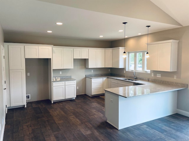 kitchen featuring dark hardwood / wood-style floors, white cabinetry, and sink