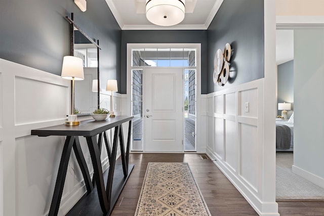 entryway with crown molding and dark hardwood / wood-style floors