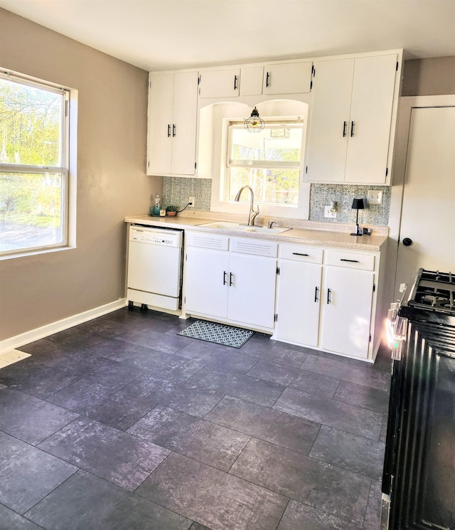 kitchen featuring gas stove, white dishwasher, sink, and white cabinets