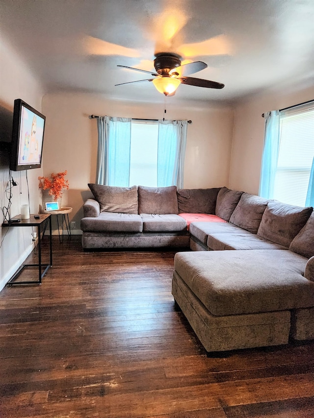 living room with dark wood-type flooring and ceiling fan