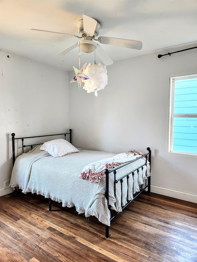 bedroom with dark wood-type flooring and ceiling fan