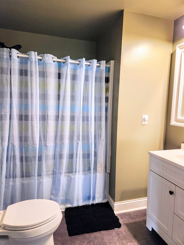 bathroom featuring vanity, curtained shower, toilet, and tile patterned floors