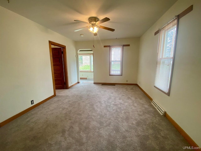 spare room with ceiling fan and light colored carpet