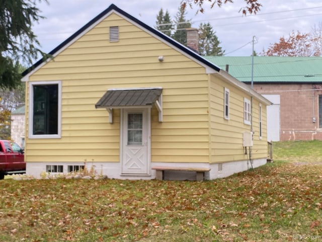 rear view of house with a yard