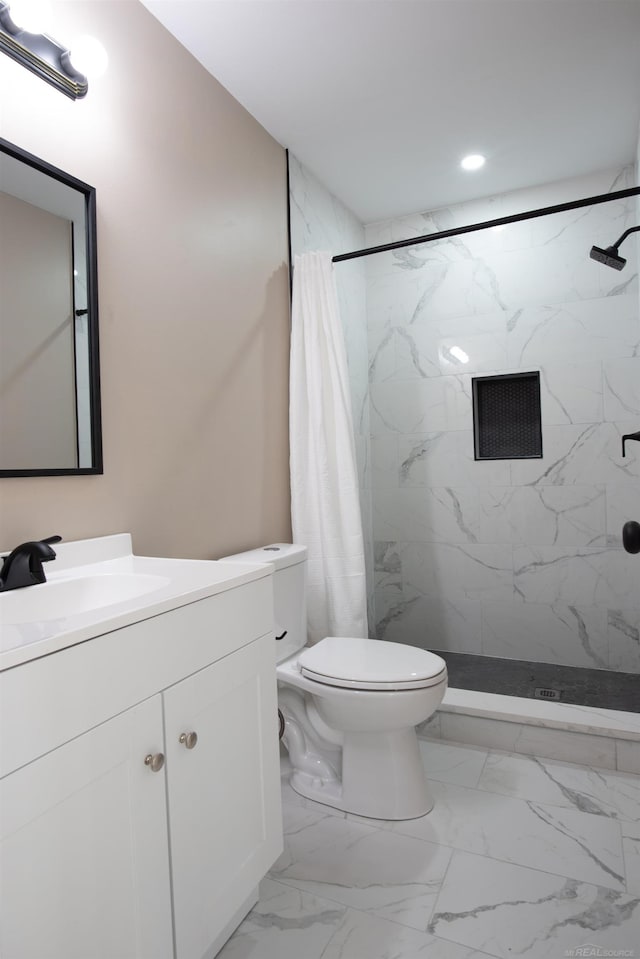 bathroom with vanity, toilet, and walk in shower