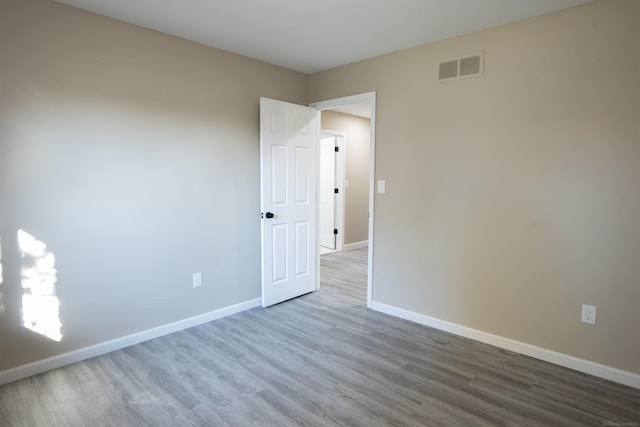 spare room with hardwood / wood-style floors