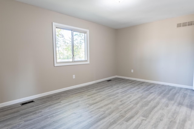 empty room with light hardwood / wood-style flooring