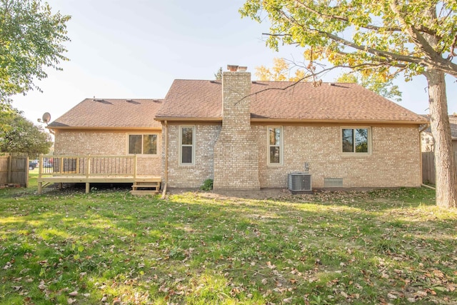 rear view of house featuring a wooden deck, a lawn, and central AC unit