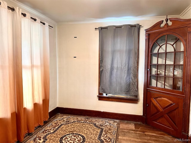 doorway with dark wood-type flooring and crown molding