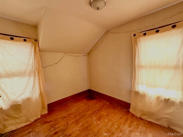 bonus room featuring wood-type flooring and vaulted ceiling