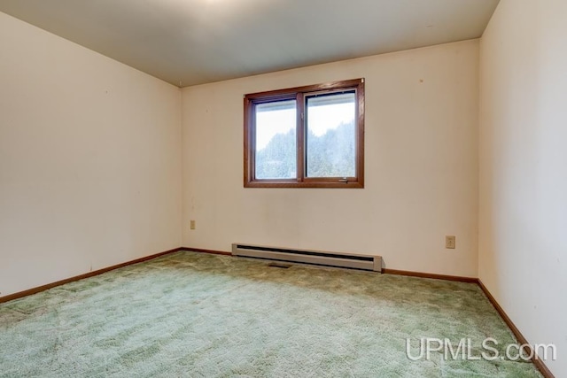 carpeted spare room with a baseboard radiator