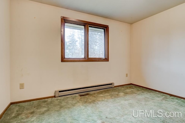 unfurnished room featuring light carpet and a baseboard heating unit