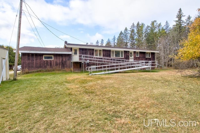 back of property featuring a lawn