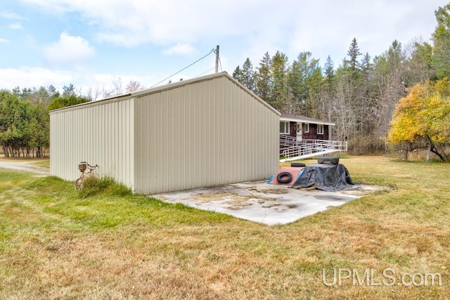 view of outbuilding with a lawn