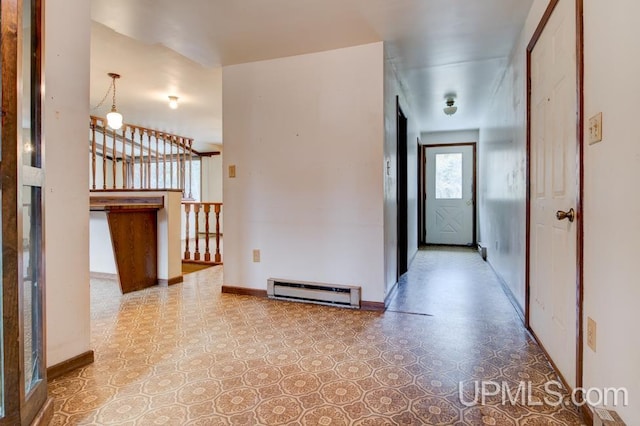 hall featuring a baseboard radiator and a chandelier