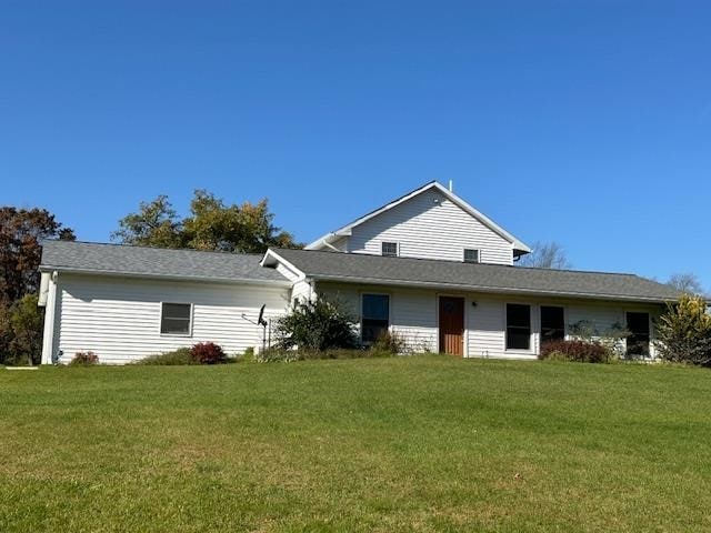 rear view of house with a yard